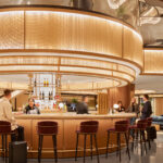 S-9 woven wire mesh in brass installed as cladding to a light feature in Chase Sapphire Lounge in LaGuardia Airport in New York.