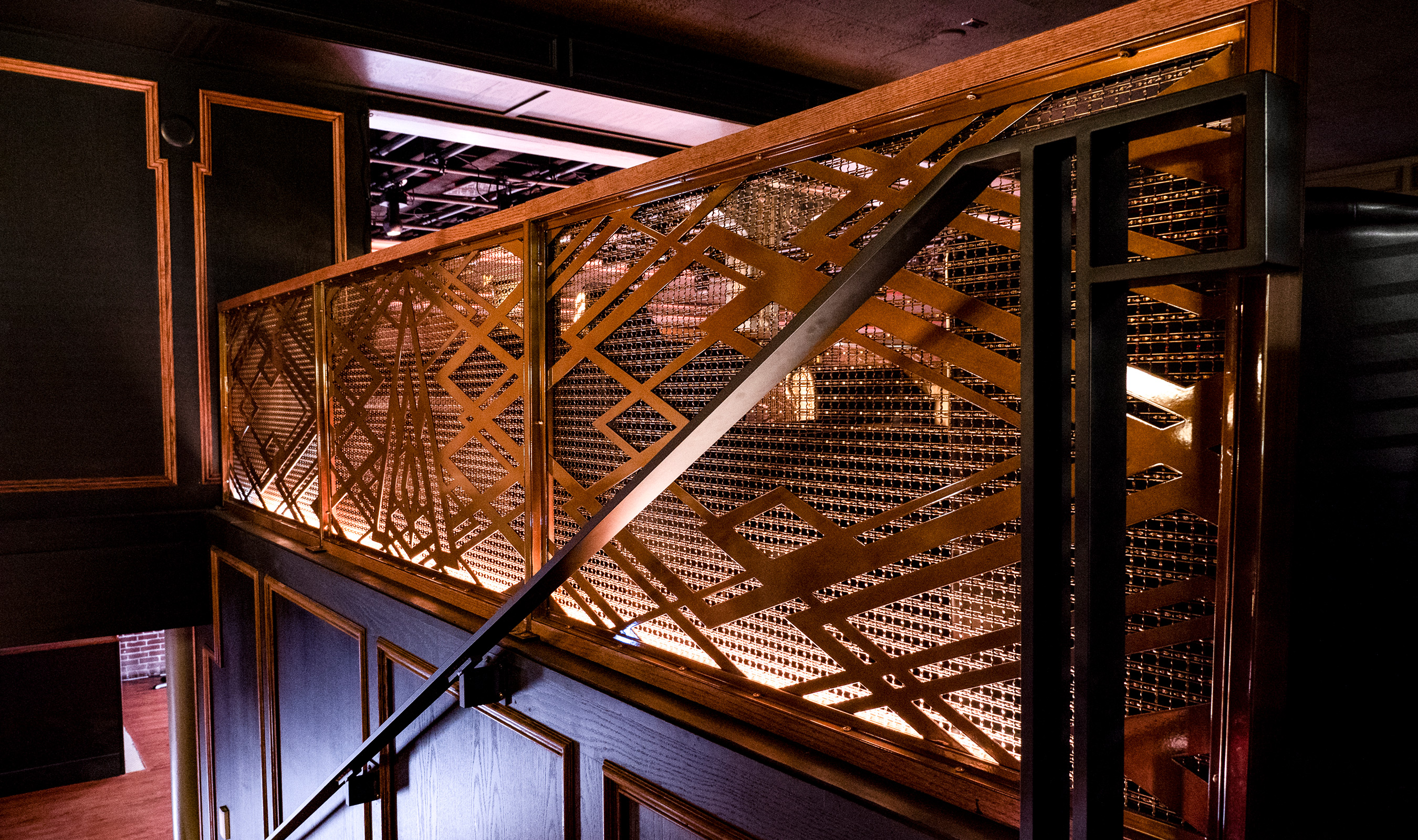 Decorative wire mesh is used as railing infill at the No Vacancy Lounge in Portland, OR.