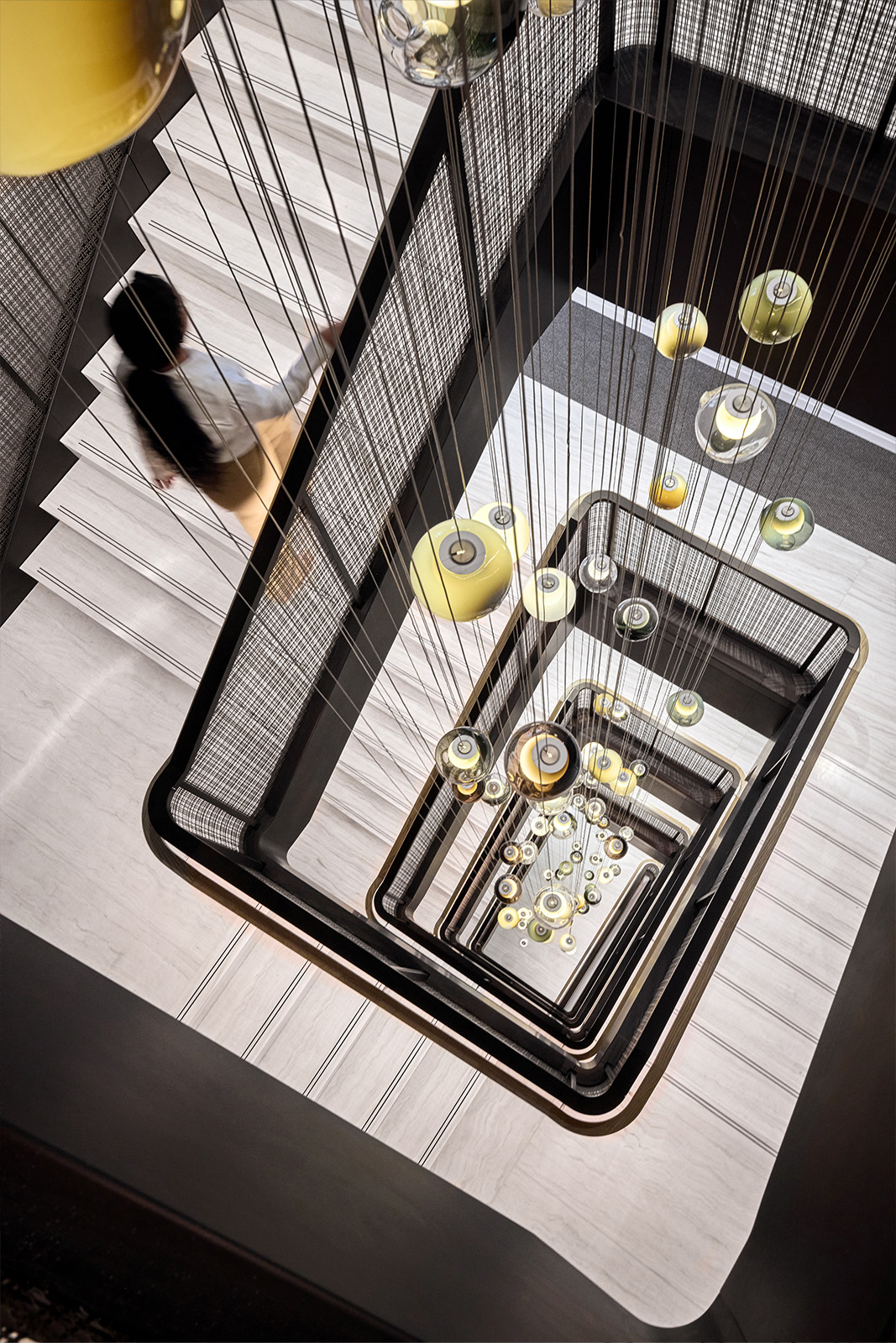 SJD-21 Woven Wire Mesh in Plated Antique Brass used in Stairwell Infill Panels allowing natural light to flow through the space