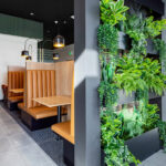 Combining clean lines and foliage, Banker Welded Wire Mesh backs this planter endcap.