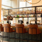 Industrial-chic bar environment with wire mesh textures and contemporary seating at Ace Porter