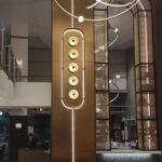 Bronze arch way framed in decorative woven wire mesh at Omni San Diego Hotel