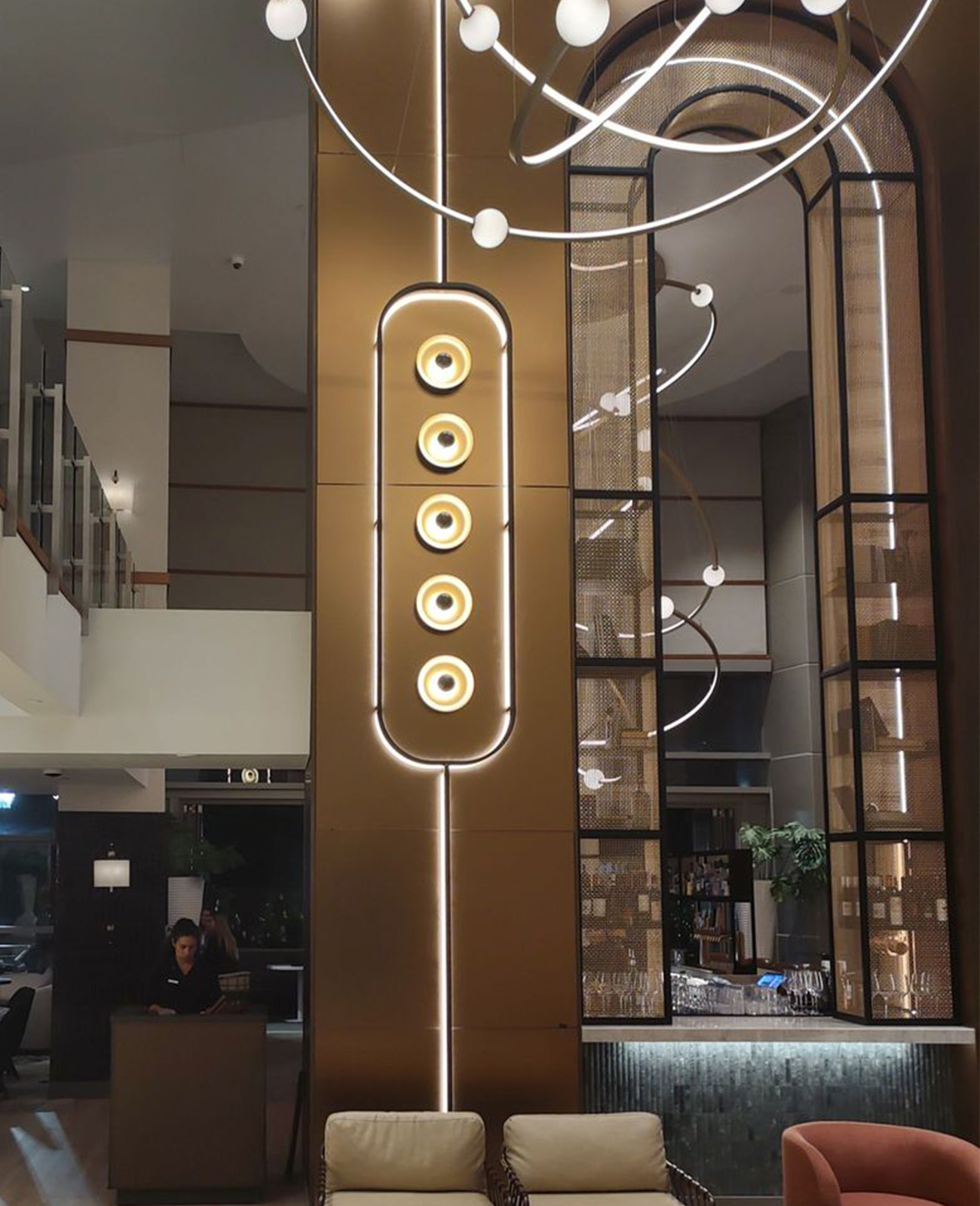 Bronze arch way framed in decorative woven wire mesh at Omni San Diego Hotel