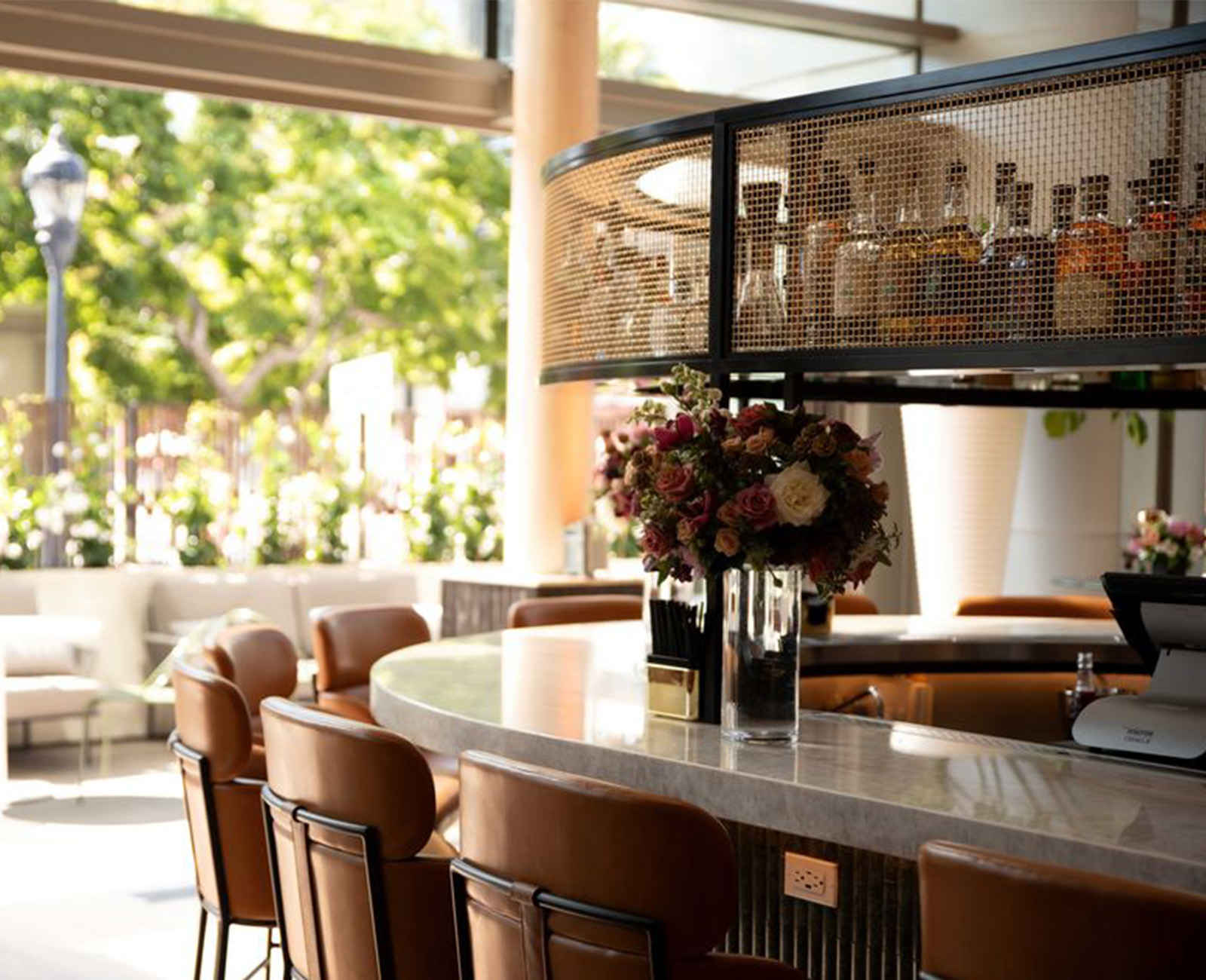 Industrial-chic bar environment with wire mesh textures and contemporary seating at Ace Porter