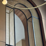 Detail of the arch way framed in bronze decorative woven wire mesh at Omni San Diego Hotel