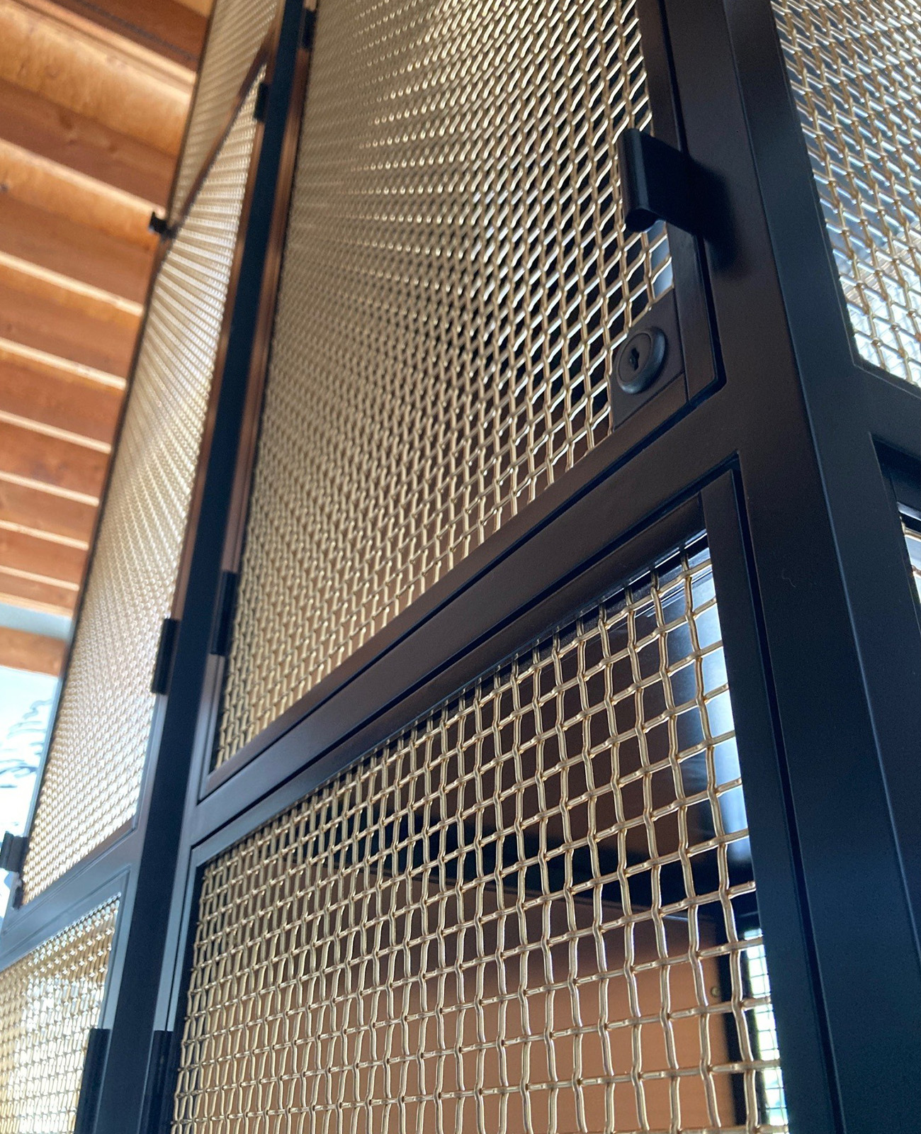 Close-up of L-441 architectural wire mesh woven in bare bronze at Ace Porter bar