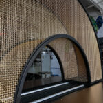 Curved bronze mesh archway designed and fabricated by Desposito Designs for the Ace Porter bar in the Omni San Diego