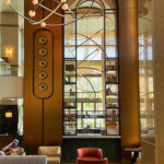 Bronze arch way framed in decorative woven wire mesh at Omni San Diego Hotel