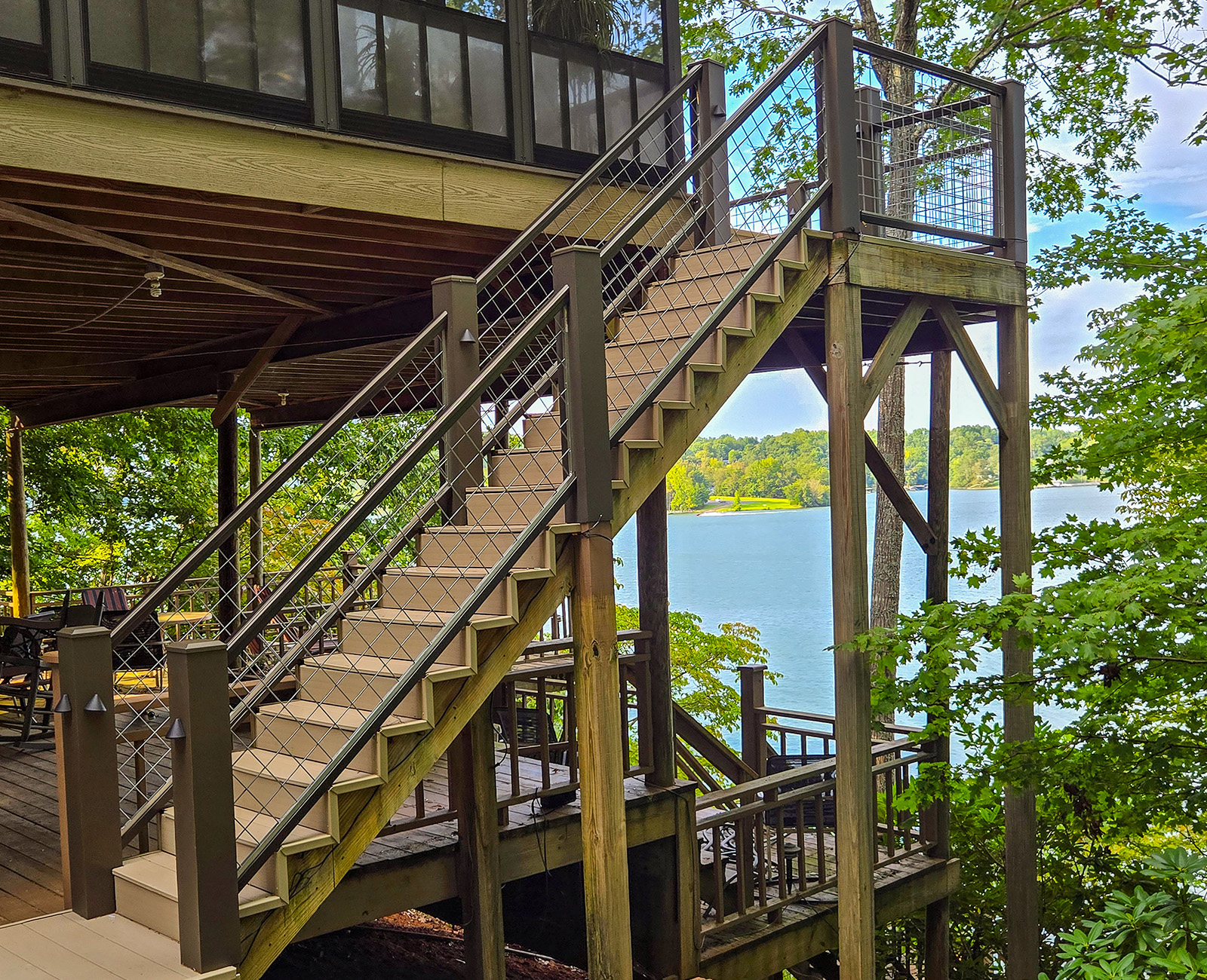 Outdoor deck with silver powder-coated welded wire mesh railing, ideal for easy DIY installation and long-term performance.