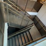 This New York project highlights the beauty and functionality of woven wire mesh in stairwell handrails. This design offers durability, light flow, and a clean aesthetic for upscale commercial spaces.