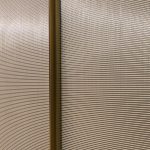 Decorative woven wire mesh IPZ-25 installed in corporate interior design as a space divider.