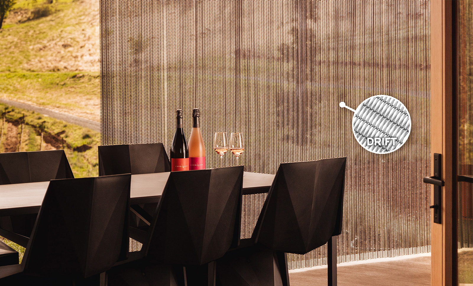 Flexible wire mesh used as a retractable curtain to act as a space divider and protect from the outdoor elements Flexible wire mesh used as a retractable curtain to act as a space divider and protect from the outdoor elements