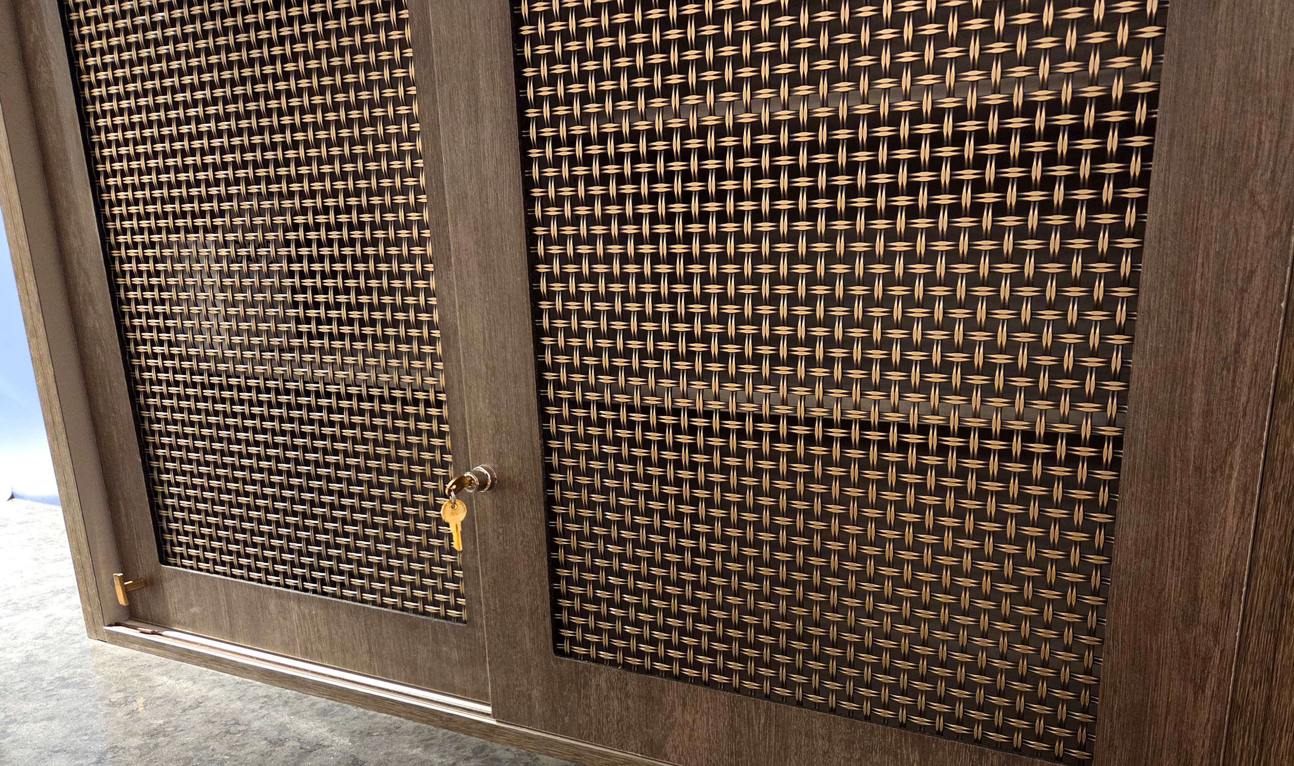 S-65 Decorative woven wire mesh in plated antique brass finish as cabinetry infill panel S-65 Decorative woven wire mesh in plated antique brass finish as cabinetry infill panel