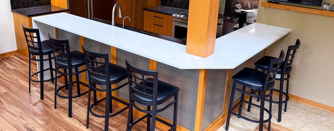 This home bar remodel highlights Banker Wire's M33-2 woven wire mesh, a decorative basket weave pattern that enhances the space with depth, texture, and timeless style.
