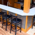 This home bar remodel highlights Banker Wire's M33-2 woven wire mesh, a decorative basket weave pattern that enhances the space with depth, texture, and timeless style.