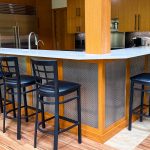Discover how Banker Wire's M33-2 woven wire mesh adds texture, depth, and sophistication to this custom home bar remodel, creating a striking architectural focal point.